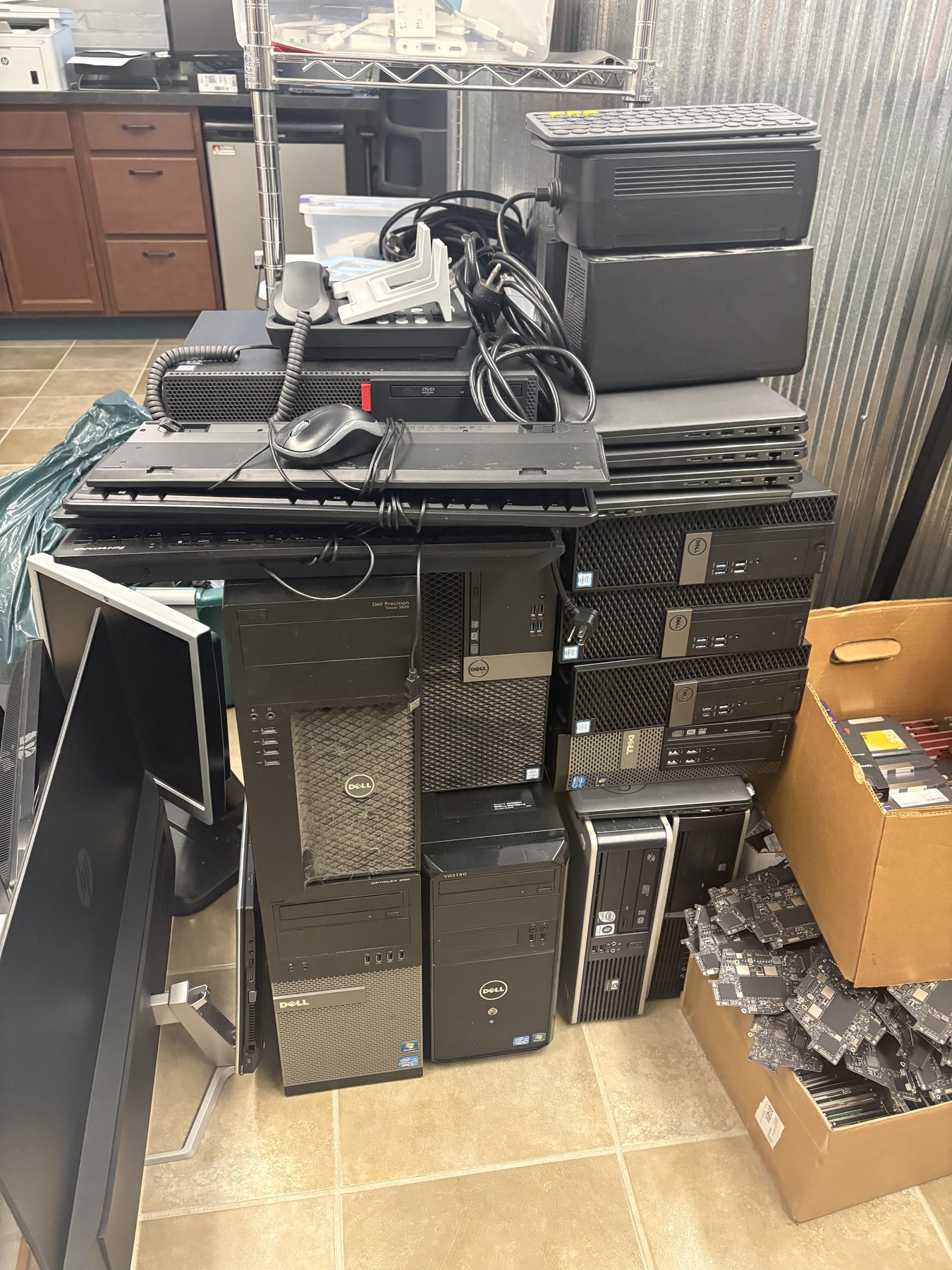 School device refresh cleanout with retired desktops, monitors, cables, and loose computer boards